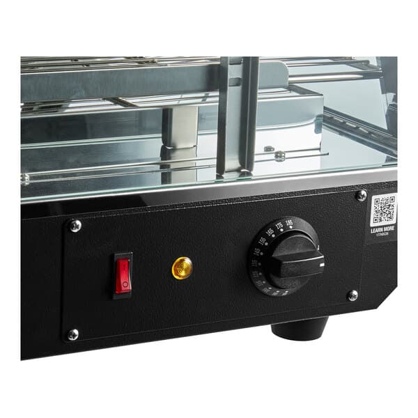 A black countertop heated display case with a temperature control knob, power switch, and glass shelves.