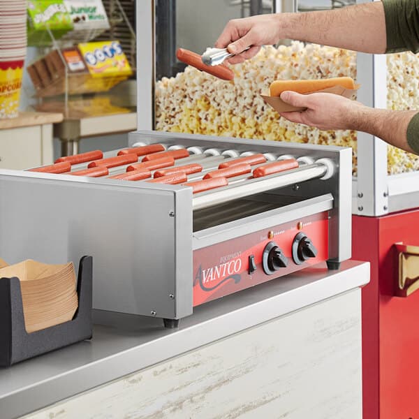 An Avantco hot dog roller grilling hot dogs.