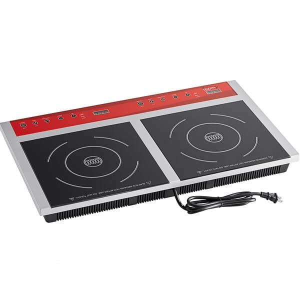 An Avantco red and black double countertop induction range on a counter with a cord.