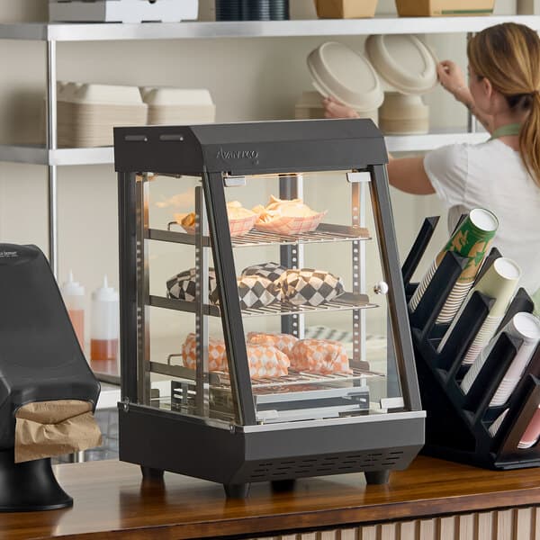 A countertop heated display case with three shelves and hinged doors, used for keeping food warm.