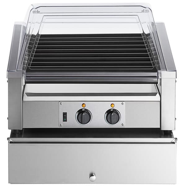An Avantco slanted hot dog roller grill with a sneeze guard over hot dogs and buns.
