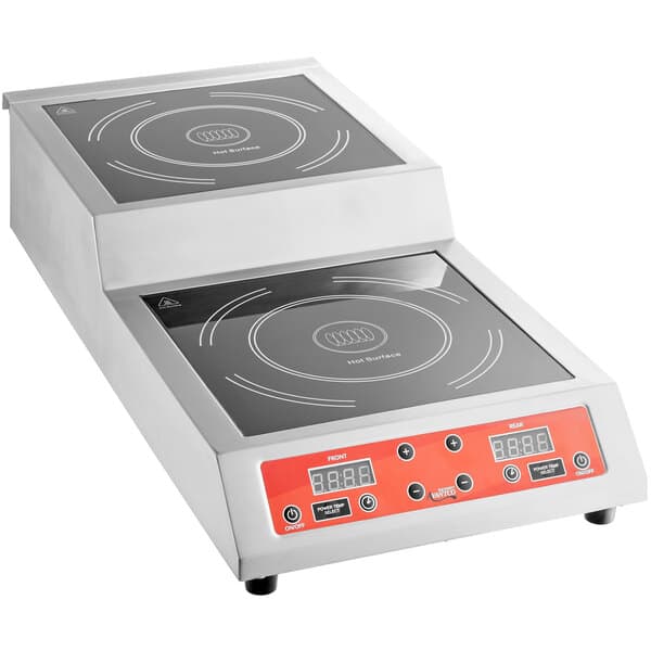 An Avantco stainless steel double countertop induction range with two burners on a counter.