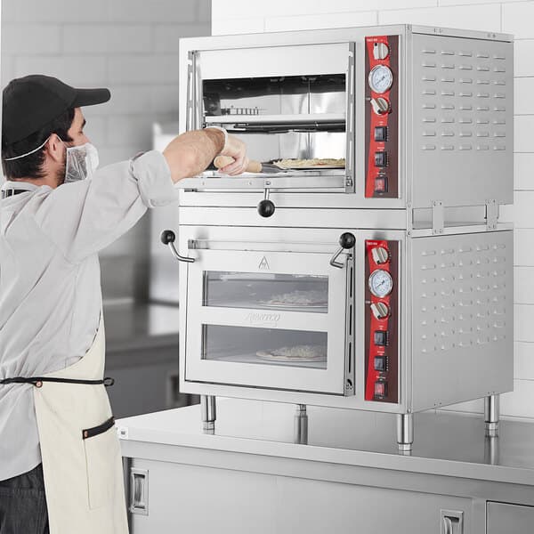 a person holding a pizza oven