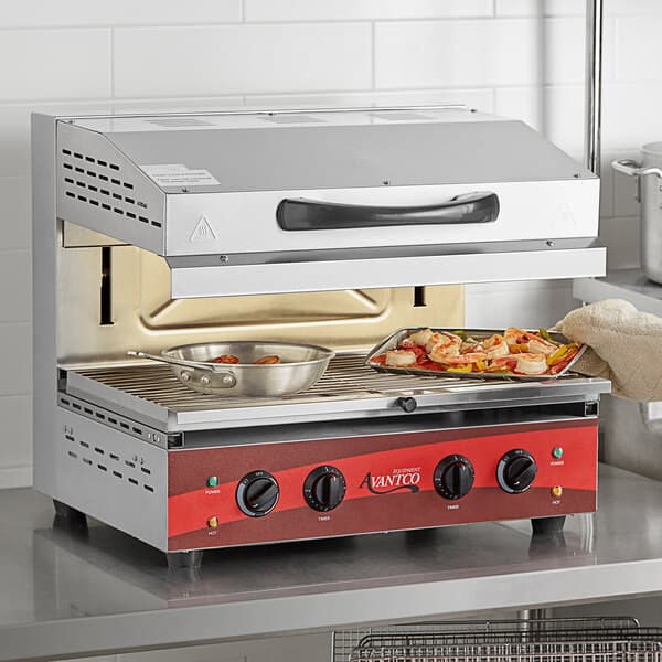 An Avantco electric countertop salamander with food in a pan.
