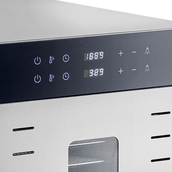 An Avantco stainless steel food dehydrator with glass doors on a counter in a professional kitchen.