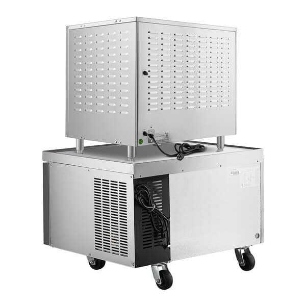 A large metal box with a white cabinet on wheels.