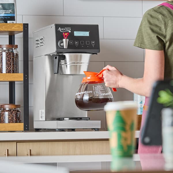 A digital automatic coffee maker with a single decanter warmer and a glass coffee decanter.