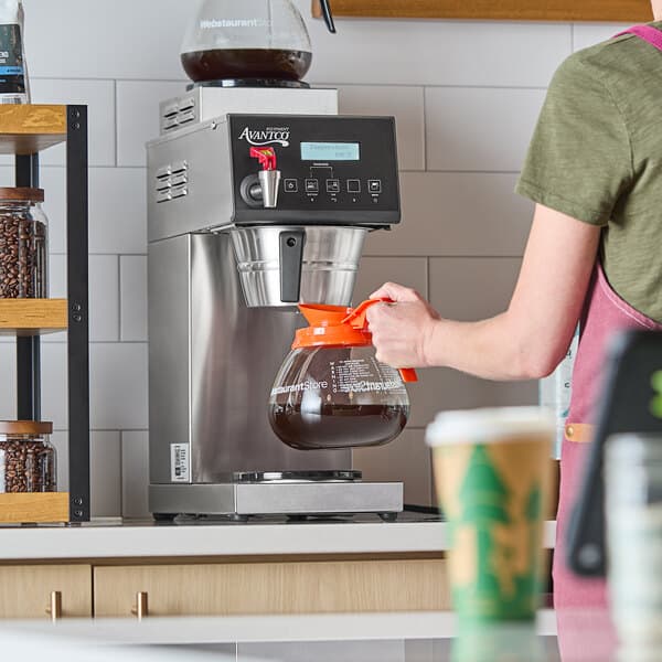 An Avantco CMAD2 digital automatic coffee maker with one upper and one lower decanter, shown in use on a countertop.