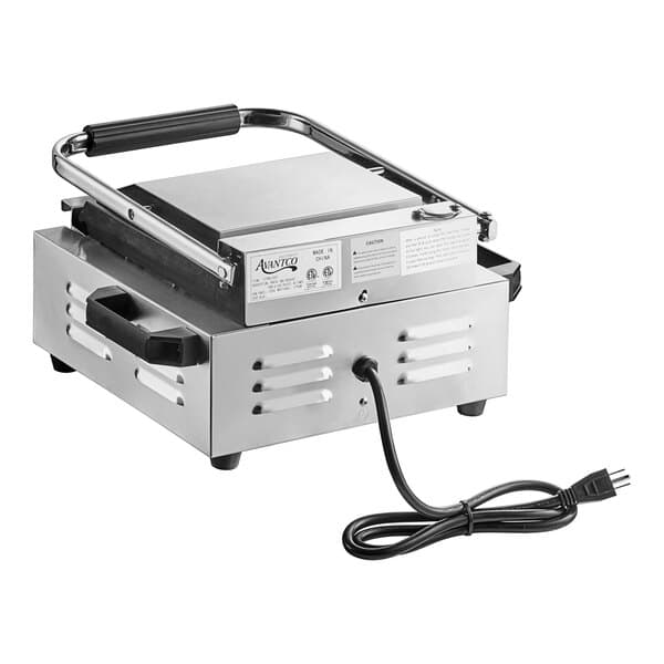 An Avantco commercial Panini grill with grooved plates and a handle.