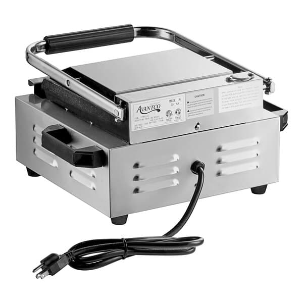 An Avantco commercial panini grill with grooved plates and a handle.