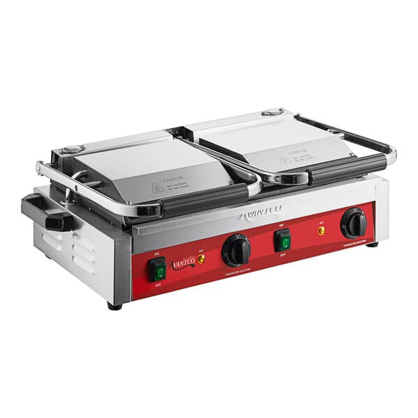 An Avantco commercial dual panini grill with red and black panels on a table.