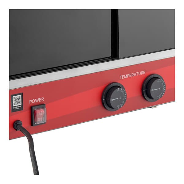 An Avantco black countertop merchandiser with red and black temperature control knobs.
