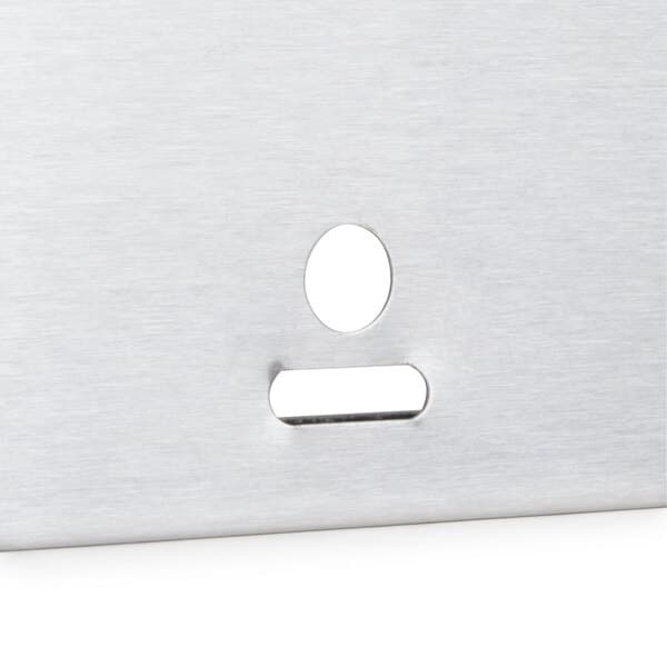 A silver metal plate with a hole in it.