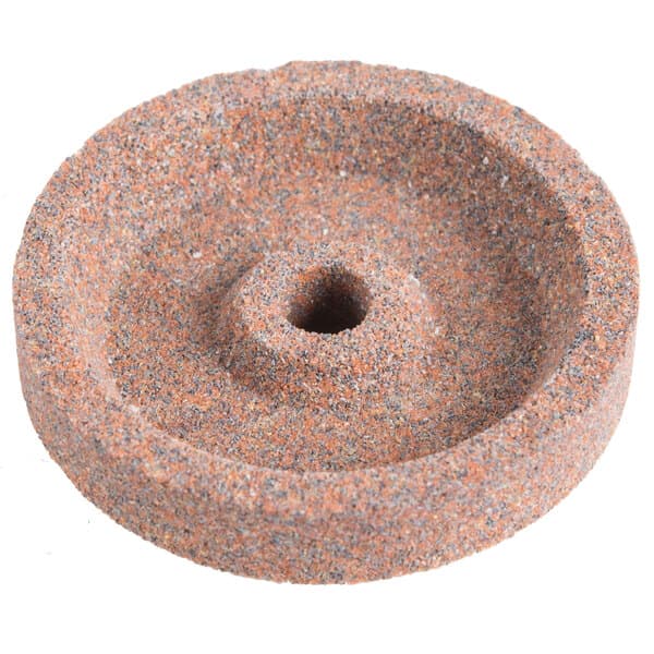 A circular stone with a hole in the middle.