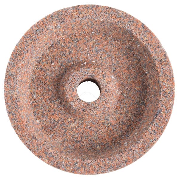 A circular stone with a hole in the middle.