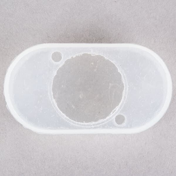 A white plastic circle with holes in it.