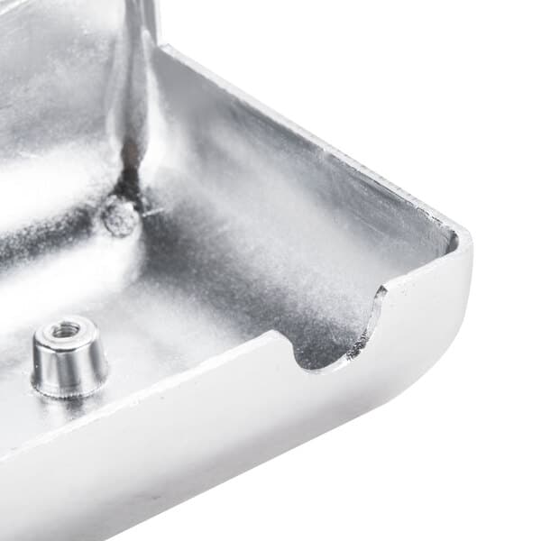 A silver metal cover with a screw on top.