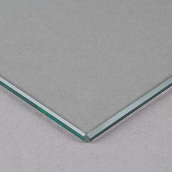 An Avantco glass panel with a silver edge.