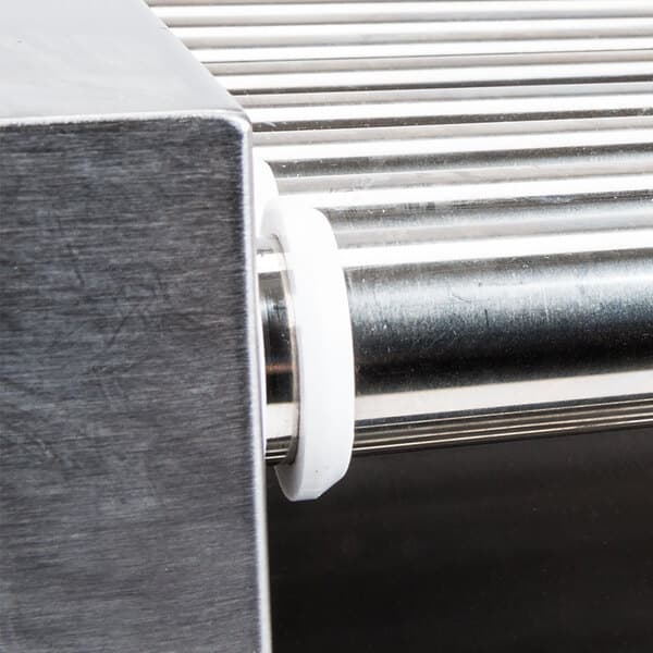 A metal roller bearing with white rubber on it.