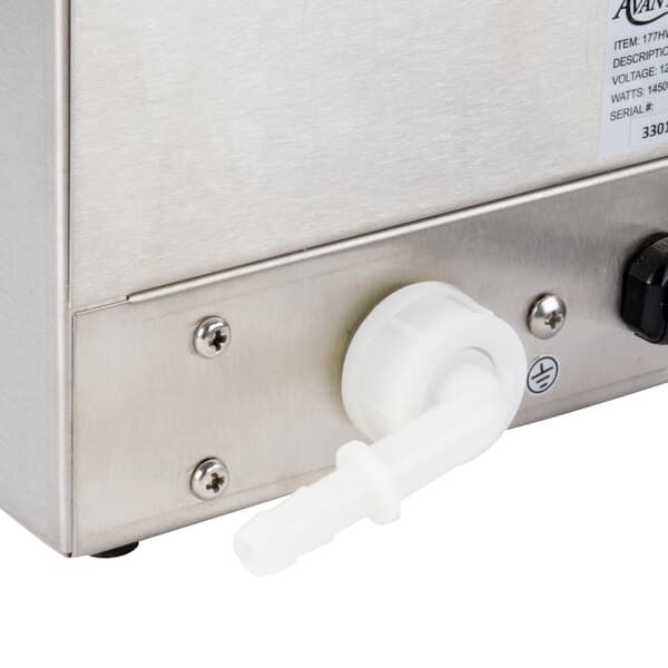 A white plastic valve on a metal box with a white plastic pipe attached to it.