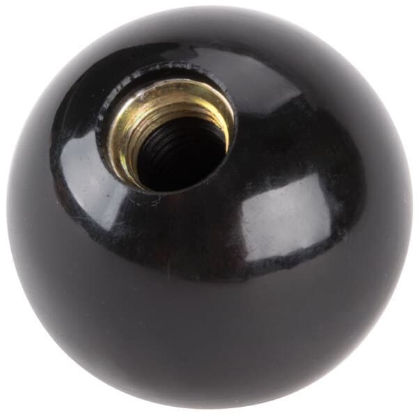 A black ball with a metal nut on it.