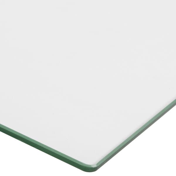 A white glass surface with a green edge.