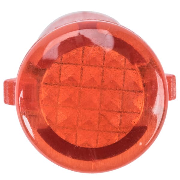 A red plastic round light with a white background.