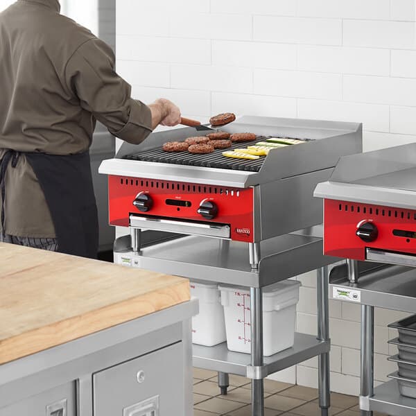 An Avantco Chef Series gas countertop charbroiler being used to cook food.
