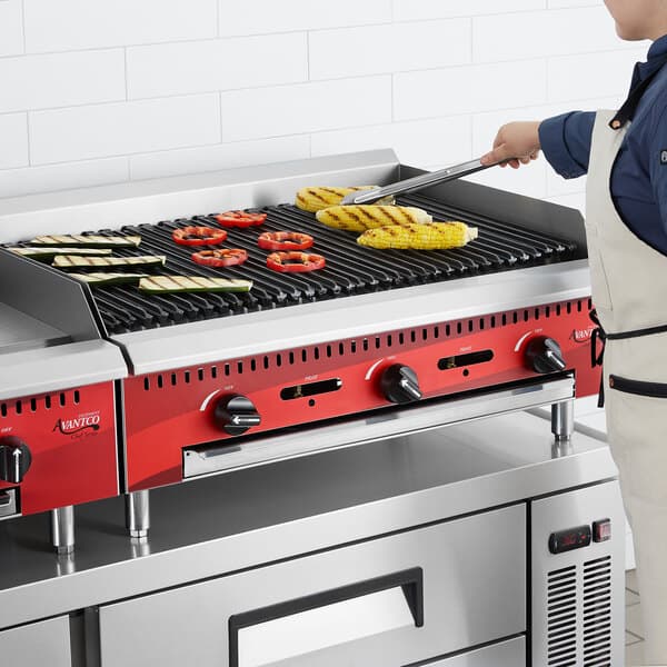 An Avantco Chef Series gas countertop charbroiler with food cooking on it.