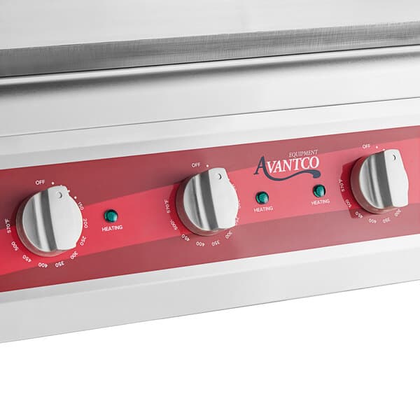 A white Avantco countertop electric griddle with red knobs.