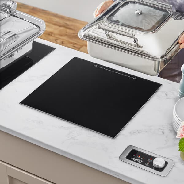 An Avantco drop-in induction chafer warmer on a countertop.