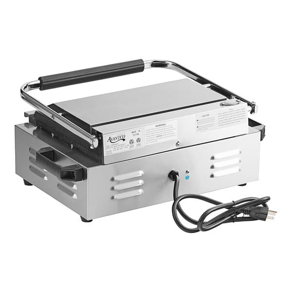 An Avantco commercial panini grill with grooved and smooth rectangular metal plates and black handles.