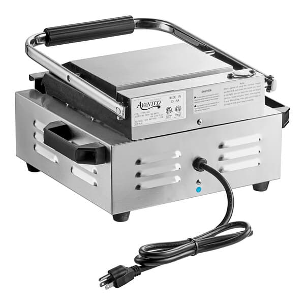 An Avantco commercial panini sandwich grill on a counter with a cord attached.