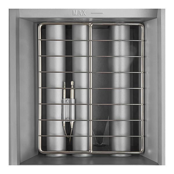 A stainless steel Avantco gas fryer with cylindrical metal objects inside.