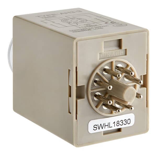 A white square timer box with metal pins.