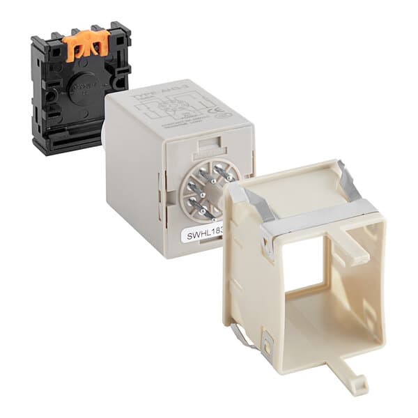 A close-up of a white plastic box with metal straps, containing a black and orange electronic switch.