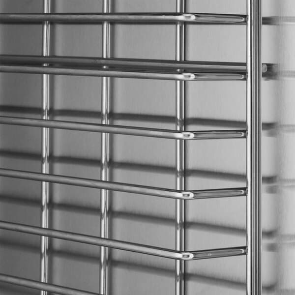 A stainless steel insulated heated holding and proofing cabinet with horizontal shelves and solid Dutch doors.